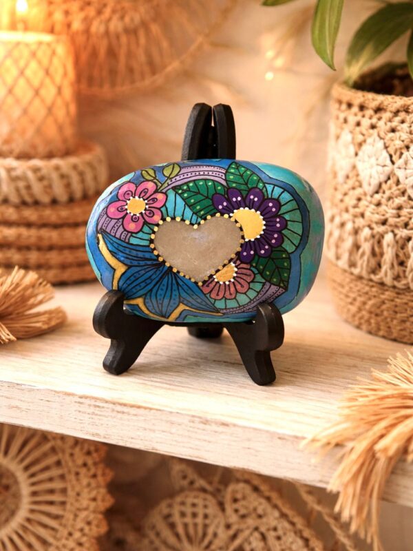 Hand painted stone with colorful heart design and hidden “Love is the answer” affirmation, mindfulness decor